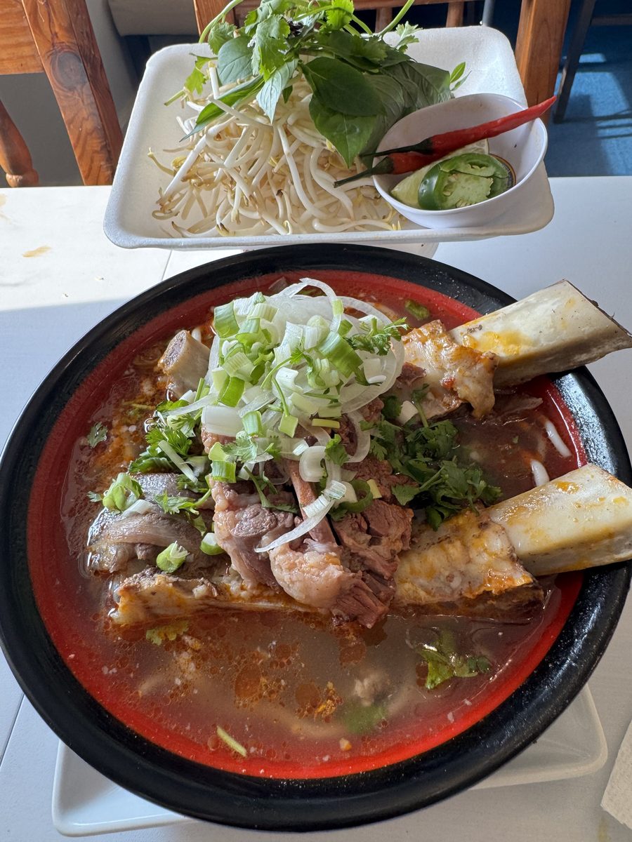 Vietnamese spicy soup with vermicelli, sliced beef and pork in red chili broth